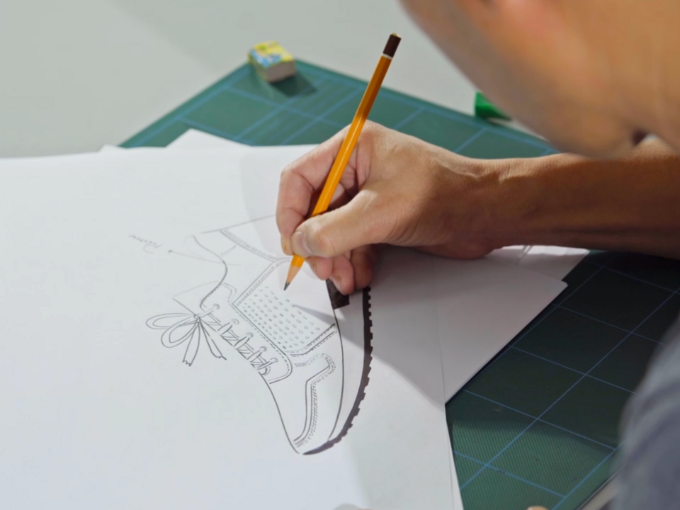 Designer fertigt eine gemalte Skizze eines remonte Schuhs an.