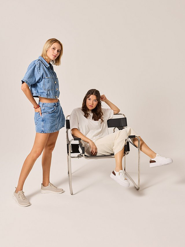 Two women are wearing spring-like everyday outfits with Rieker sneakers.