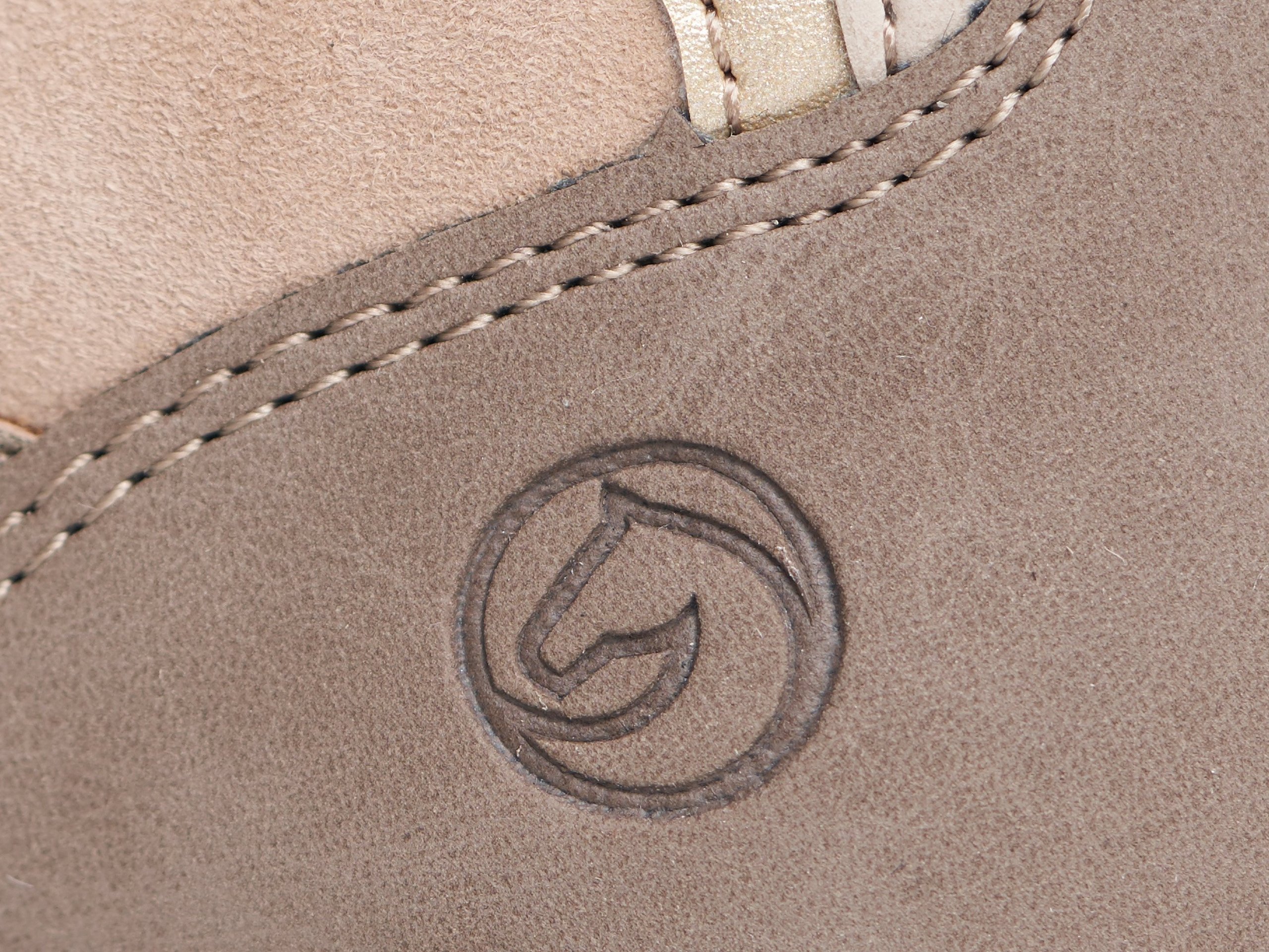 Shoe detail with embossed remonte logo in close-up