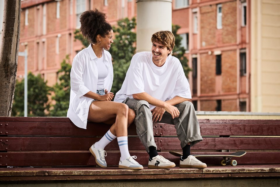 A woman and a man sit next to each other and talk.